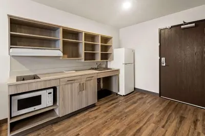 a kitchen with a microwave and a refrigerator at WoodSpring Suites Easton Nazareth in Easton