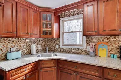 a kitchen with wooden cabinets and a sink at 3BD Stevens Universe Theme - Games - Backyard in Tobyhanna