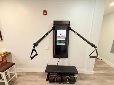 a room with a stand up tv on a wall at The Luxury Suite - 1BR with Gym & Office in Paterson