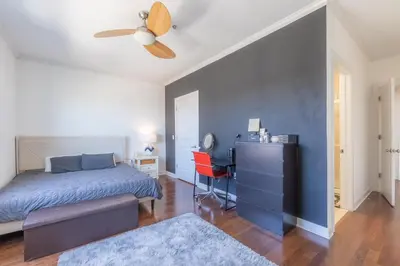 a bedroom with a blue bed and a desk at King Master and Plush Queen near NYC w kitchen, living room plus on-site gym in Jersey City