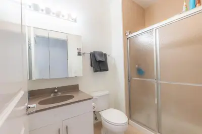 a bathroom with a shower and a toilet and a sink at King Master and Plush Queen near NYC w kitchen, living room plus on-site gym in Jersey City