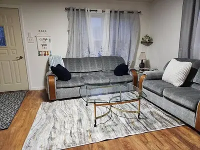 a living room with a couch and a glass coffee table at Cozy 3BR Home near Downtown Lancaster in Lancaster