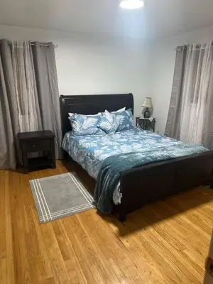 a bedroom with a bed with a blue comforter at Cozy 3BR Home near Downtown Lancaster in Lancaster