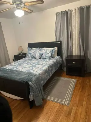 a bedroom with a bed with a blue comforter at Cozy 3BR Home near Downtown Lancaster in Lancaster