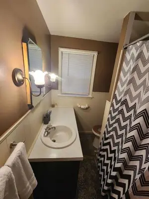 a bathroom with a sink and a toilet at Cozy 3BR Home near Downtown Lancaster in Lancaster