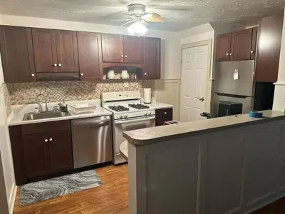 a kitchen with a sink and a stove top oven at Cozy 3BR Home near Downtown Lancaster in Lancaster