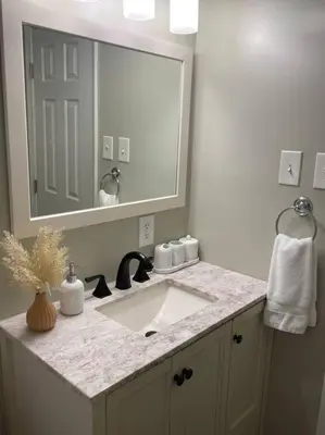 a bathroom with a sink and a large mirror at Perfect Lehigh Valley Oasis in Bethlehem