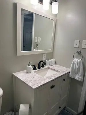 a bathroom with a sink and a mirror at Perfect Lehigh Valley Oasis in Bethlehem