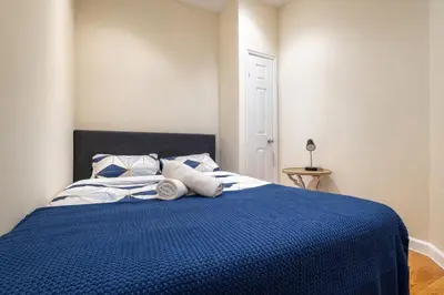 a bedroom with a blue bed with towels on it at 4 Bedroom Paradise next to Central Park in New York