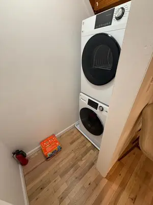 a washer and dryer in a corner of a room at Luxury Boutique Home - 5 Beds 2 Baths 25 minutes to NYC in Jersey City