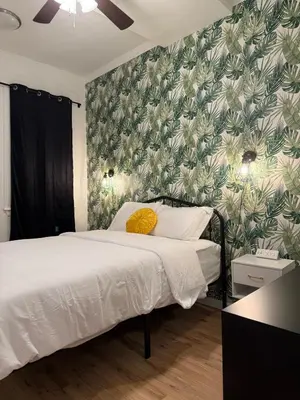a bedroom with a bed with a green and white wallpaper at Luxury Boutique Home - 5 Beds 2 Baths 25 minutes to NYC in Jersey City