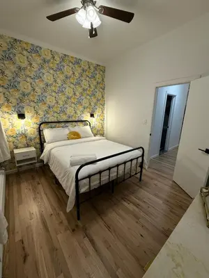 a bedroom with a bed and a ceiling fan at Luxury Boutique Home - 4 Beds 1 Baths 25 minutes to NYC in Jersey City