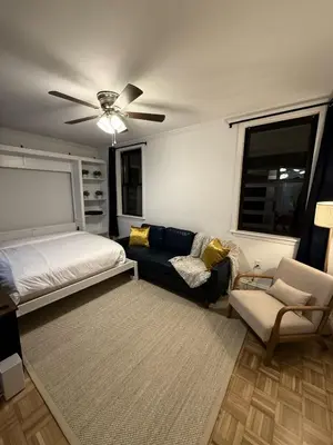 a living room with a couch and a bed at Luxury Boutique Home - 4 Beds 1 Baths 25 minutes to NYC in Jersey City