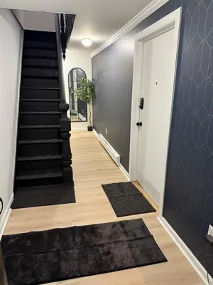 a hallway with a staircase with a black rug at Luxury Boutique Home - 4 Beds 1 Baths 25 minutes to NYC in Jersey City