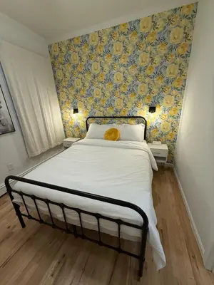 a bedroom with a large bed with a floral wallpaper at Luxury Boutique Home - 4 Beds 1 Baths 25 minutes to NYC in Jersey City