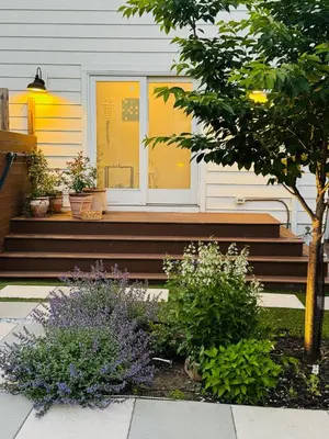 a house with some plants on the stairs at Designer cozy 1 private bedroom w full bath & yard 20 min to nyc in Harrison