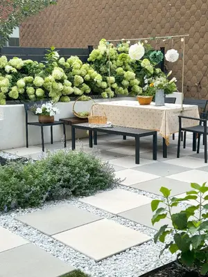 a patio with a table and chairs and plants at Designer cozy 1 private bedroom w full bath & yard 20 min to nyc in Harrison