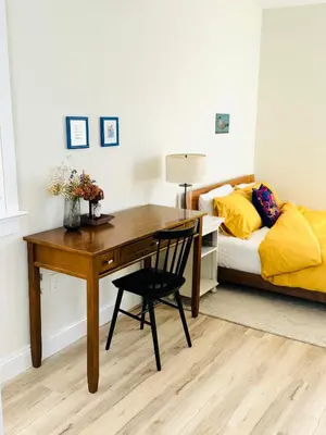 a desk in a bedroom with a bed and a desk at Designer cozy 1 private bedroom w full bath & yard 20 min to nyc in Harrison