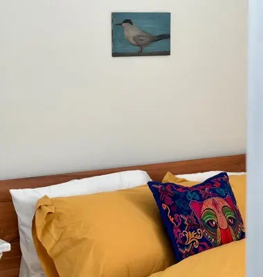 a bedroom with a bed with a bird on the wall at Designer cozy 1 private bedroom w full bath & yard 20 min to nyc in Harrison