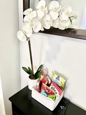 a black table with a flower on a shelf at Apart Studio West NYNJ 12Mints From NYCity TimeSquare in West New York