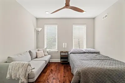 a living room with a couch and a ceiling fan at Getaway in the heart of the city in Philadelphia