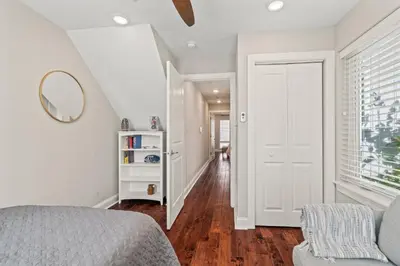 a white bedroom with a bed and a mirror at Getaway in the heart of the city in Philadelphia