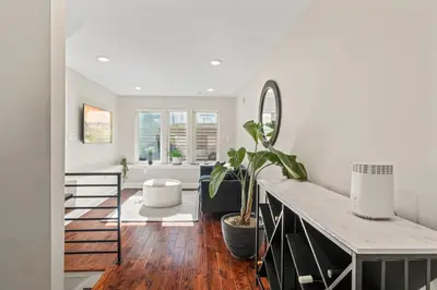 a living room with a table and a potted plant at Getaway in the heart of the city in Philadelphia