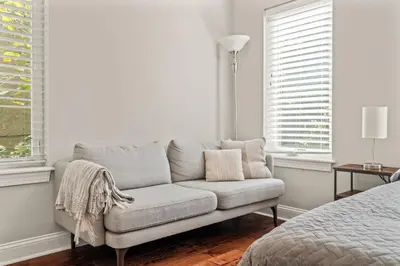 a couch in a room with a bed and windows at Getaway in the heart of the city in Philadelphia