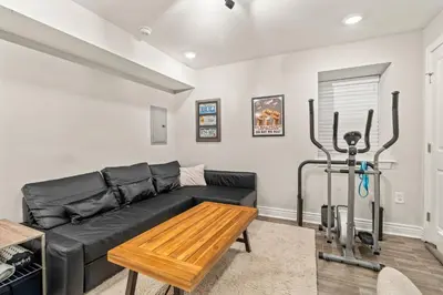 a living room with a black couch and a table at Getaway in the heart of the city in Philadelphia