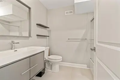 a white bathroom with a toilet and a sink at Getaway in the heart of the city in Philadelphia