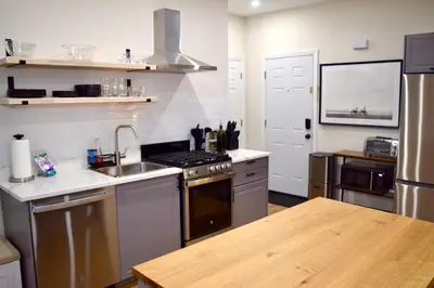 a kitchen with a sink and a stove top oven at Newly Renovated 1 Bedroom Executive Apartment in Kearny