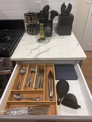 a kitchen counter with utensils in a drawer at Newly Renovated 1 Bedroom Executive Apartment in Kearny