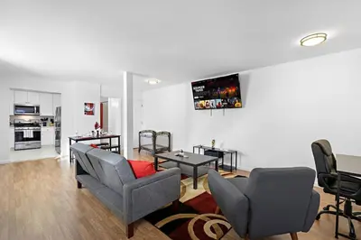 a living room with a couch and chairs and a table at Cozy Family Getaway - NYC & NWK with free parking in Bayonne