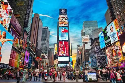 a crowd of people crossing a busy city street at Cozy Family Getaway - NYC & NWK with free parking in Bayonne