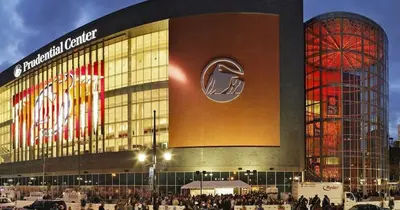 a large building with people standing outside of it at Cozy Family Getaway - NYC & NWK with free parking in Bayonne