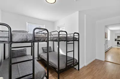 a bedroom with two bunk beds in a room at Cozy Family Getaway - NYC & NWK with free parking in Bayonne