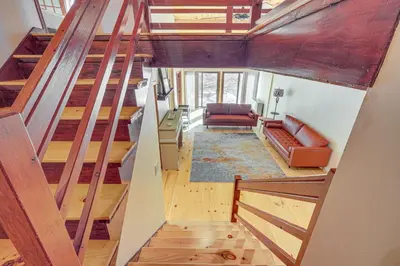 an overhead view of a living room with wooden stairs at Ski, Hike and More Spacious Log Cabin in Long Pond in Long Pond