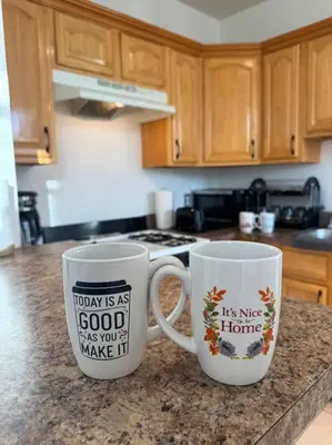 two coffee mugs sitting on top of a kitchen counter at For NYC visitors 9min to NYC train-15min to EWR in Bayonne