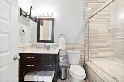 a bathroom with a toilet and a sink and a shower at High-End 1BR with Rooftop Amenities in Philadelphia
