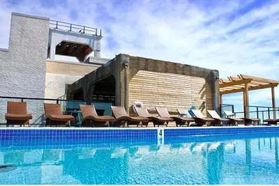 a swimming pool with chairs next to a building at High-End 1BR with Rooftop Amenities in Philadelphia