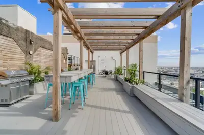a balcony with tables and chairs on a building at High-End 1BR with Rooftop Amenities in Philadelphia