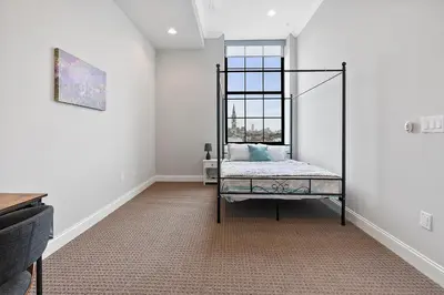 an empty room with a bed in a room at High-End 1BR with Rooftop Amenities in Philadelphia