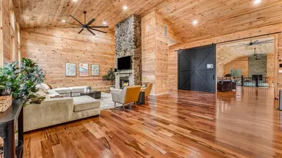 a living room with a couch and a fireplace at Grand Timber by AvantStay Indoor Pool Sports Court Game Room More in White Haven
