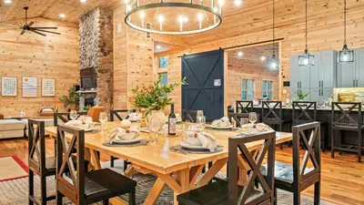 a dining room with a large wooden table and chairs at Grand Timber by AvantStay Indoor Pool Sports Court Game Room More in White Haven