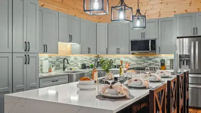 a kitchen with white cabinets and a large white counter top at Grand Timber by AvantStay Indoor Pool Sports Court Game Room More in White Haven