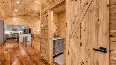 a wooden barn with a door in a kitchen at Grand Timber by AvantStay Indoor Pool Sports Court Game Room More in White Haven