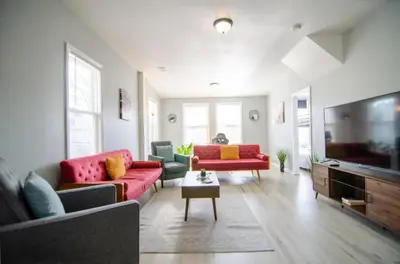 a living room with red couches and a tv at Near NYC Spacious 4 bedroom 2 and a half bath in North Bergen