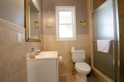a bathroom with a toilet and a sink and a mirror at Near NYC Spacious 4 bedroom 2 and a half bath in North Bergen
