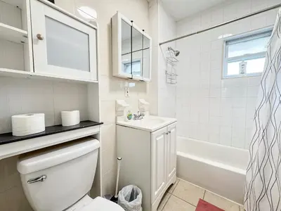a bathroom with a toilet and a sink and a tub at 3 bed 1 bath FREE parking near NYC in North Bergen