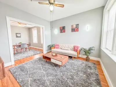a living room with a couch and a table at 3 bed 1 bath FREE parking near NYC in North Bergen